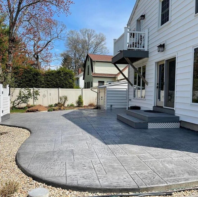 A stamped concrete patio with concrete steps