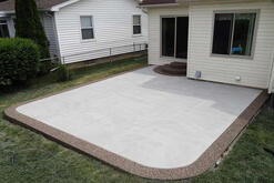 A concrete patio with a stamped edge